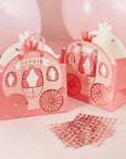 Two Pink Princess Carriage Favour Bags with crown designs and ribbon handles are shown beside pink balloons and rose gold metallic letter stickers for customization. One bag displays the name Sophie.