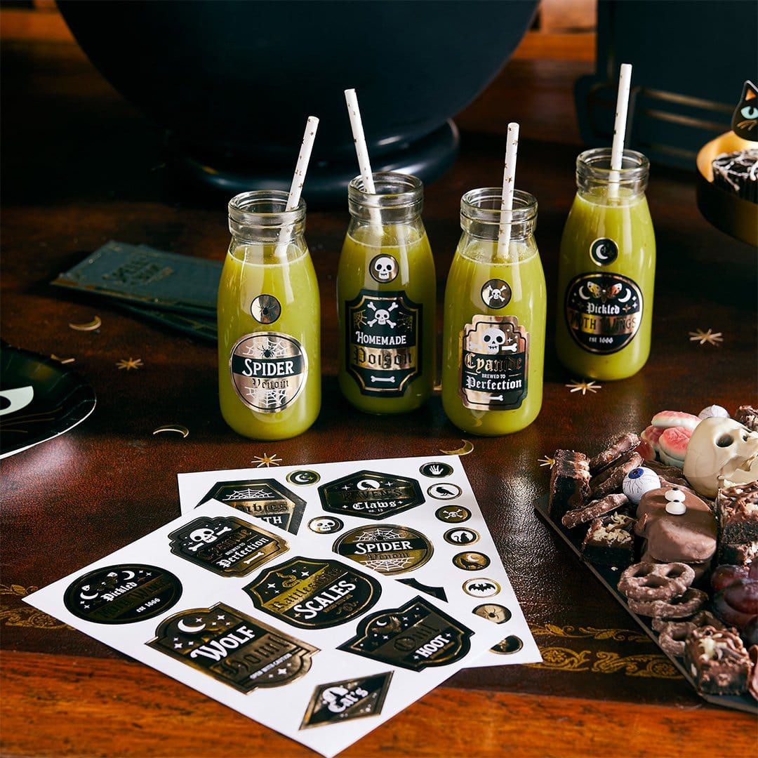Halloween potion bottle labels stickers with spooky names like Spider Venom and Homemade Poison, DIY drink labels for Halloween party beverages, witch potion stickers for mason jars and bottles with Halloween candy decorations