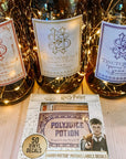 Three potion bottles with ornate labels—“Memory Potion,” “Draught of Peace,” and “Pepperup Potion”—are illuminated by fairy lights. In front lies a set of Harry Potter Potions Label Decals, perfect for adding magical details to any surface.