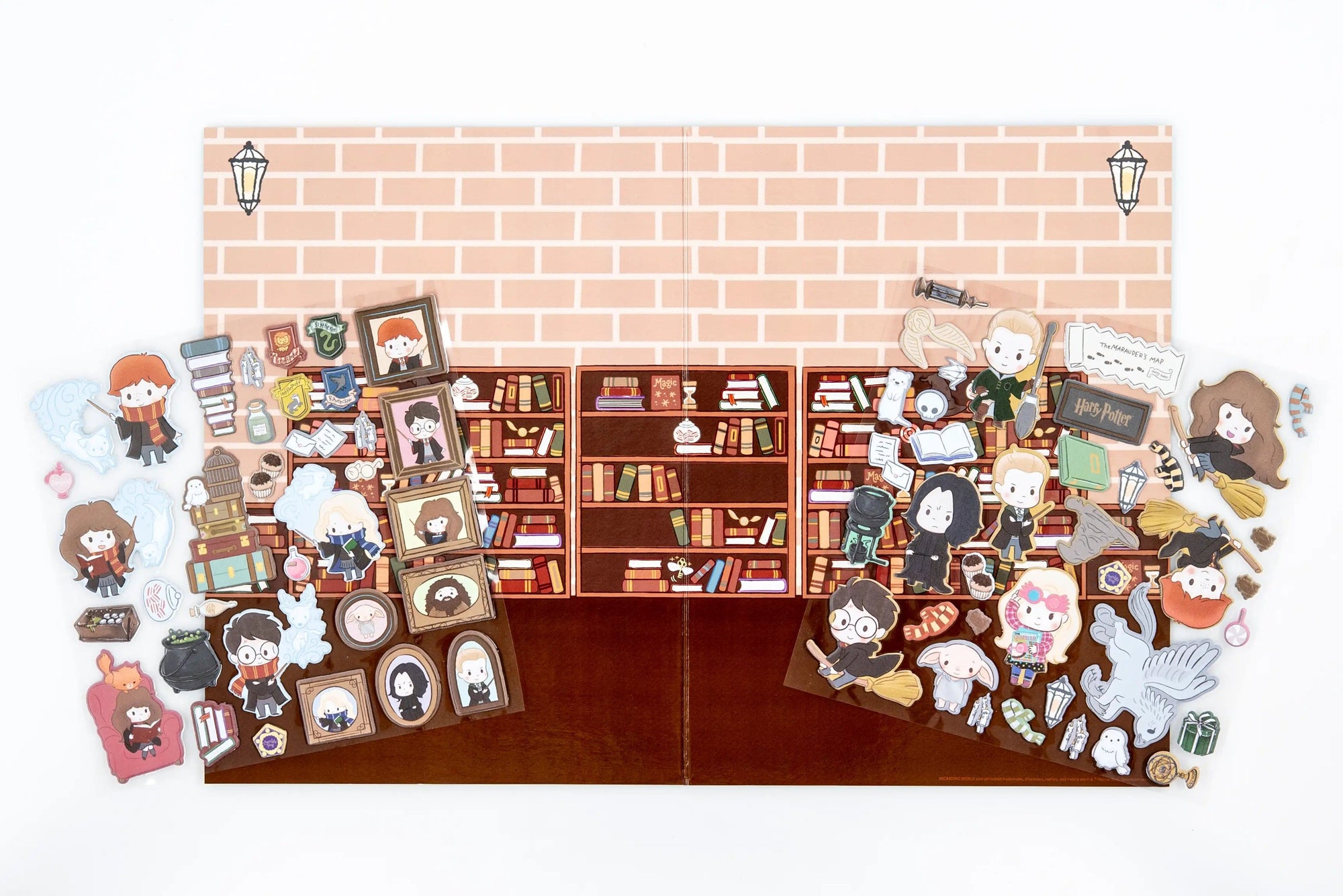 The Hogwarts Puffy Sticker Playset features a flat lay of themed puffy stickers—characters, magical creatures, books, and iconic items—arranged around an illustrated bookshelf backdrop for a magical play scene.