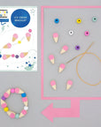 Cotton Twist ice cream bracelet craft kit contents laid out showing beads, elastic cord, and instruction booklet - complete DIY jewelry making set ideal for party activities, Easter basket filler, and creative gifts