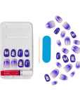Complete contents of KISS x Wicked For Good Glow With Glinda press-on nail kit laid flat showing 28 purple themed nails in tray and loose, pink gel nail glue, mini file, and manicure stick, perfect for Wicked themed parties or gifts