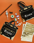 DIY customizable Halloween cauldron loot bags craft kit with gold letter stickers, includes personalization supplies for Halloween party planning and children's party favours