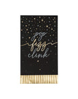 Black and gold paper party napkins with gold text 'pop fizz clink' and star patterns on a white background