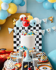 Race car party decorations with tire plates checkered balloons Happy Birthday banner - racing themed cake table setup with car party supplies