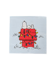 Cartoon snoopy doghouse covered in Christmas tree lights on a light blue background