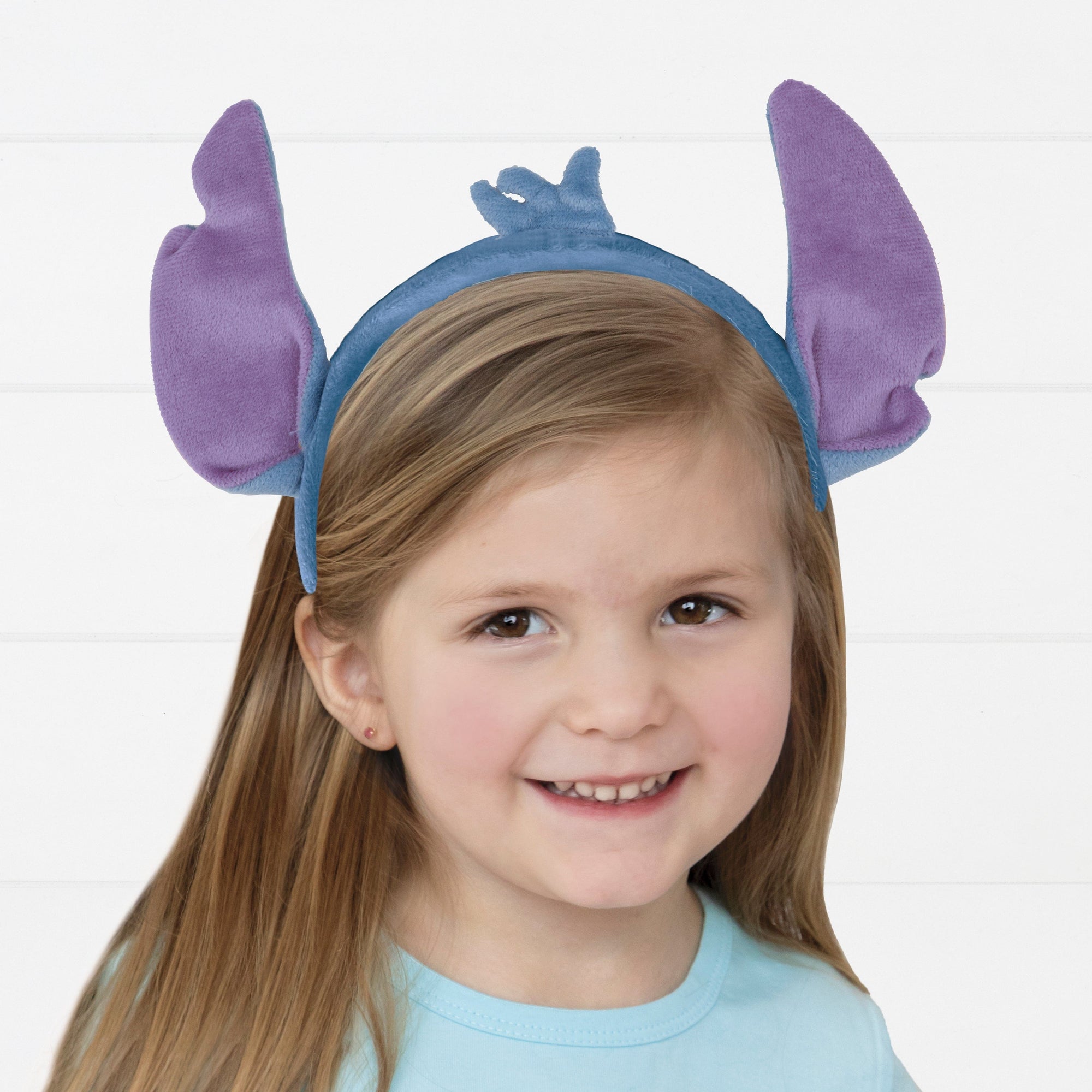 Child wearing Stitch ears headband Disney costume accessory - kids birthday party dress-up supplies and character headwear