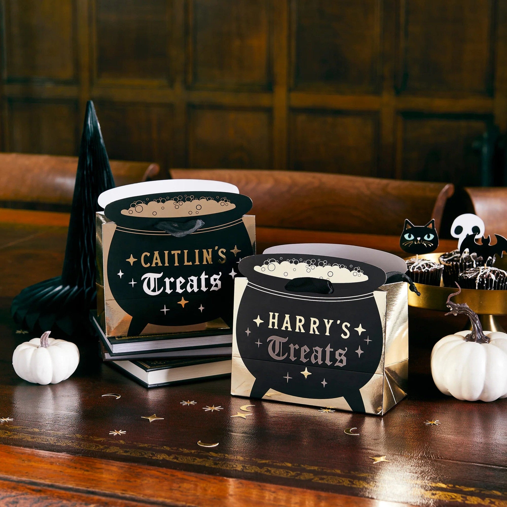 Personalized Halloween cauldron favour bags with custom names, black witch cauldron treat bags with gold foil accents, perfect for Halloween party favours and trick-or-treat loot bags