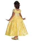 Back view of Disney Belle prestige costume dress showing layered yellow tulle overskirt and gold foil print ball gown skirt; girls' costume dress