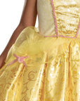 Close-up of Disney Belle costume dress yellow tulle overskirt with pink rose bow and gold Beauty and the Beast foil print ball gown skirt