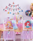 Disney Princess birthday party table with foil balloon bouquets, Happy Birthday banner, princess chair backs & Once Upon A Time tablecloth