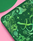 Emerald City Wicked plate closeup showing green glitter foil witch hat, broom, and hot air balloon details