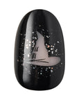 Close-up of Kiss x Wicked For Good Elphaba Own Your Power black oval press-on nail featuring Elphaba's witch hat nail art with silver glitter