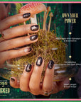 Kiss x Wicked For Good Own Your Power campaign showing black Elphaba hat and broom costume nails with callouts: glow-in-the-dark effect, short oval shape