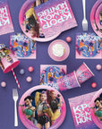 K-Pop Demon Hunters birthday party tableware overhead view with place settings plates cups and napkins on purple table