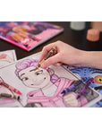 Child colouring a Rumi page from the Kpop Demon Hunters colouring book with Crayola crayons