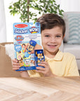 Child holding Melissa and Doug PAW Patrol Sticker WOW set with 300 stickers and Chase stamper, ideal birthday party activity and gift for kids ages 3-7