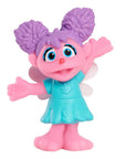 Sesame Street Abby Cadabby mini figurine for a cake topper or party favour, pink body and teal dress with purple pom-pom pigtails and blue eyes
