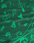 Wicked tablecloth green Elphaba side closeup showing witch hat broom butterfly crown and Emerald City pattern
