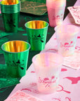 Wicked themed Popular and Unlimited party cups styled on table with matching pink and green napkins for party table decor