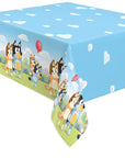 The Bluey Clouds Table Cover features Bluey and Bingo on the edges, a blue sky with white clouds, and festive balloons—ideal for any Bluey Collection party.