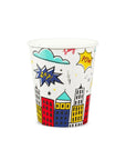 A paper cup with colorful comic book inspired design, featuring buildings and superhero motifs, and silver foil details.