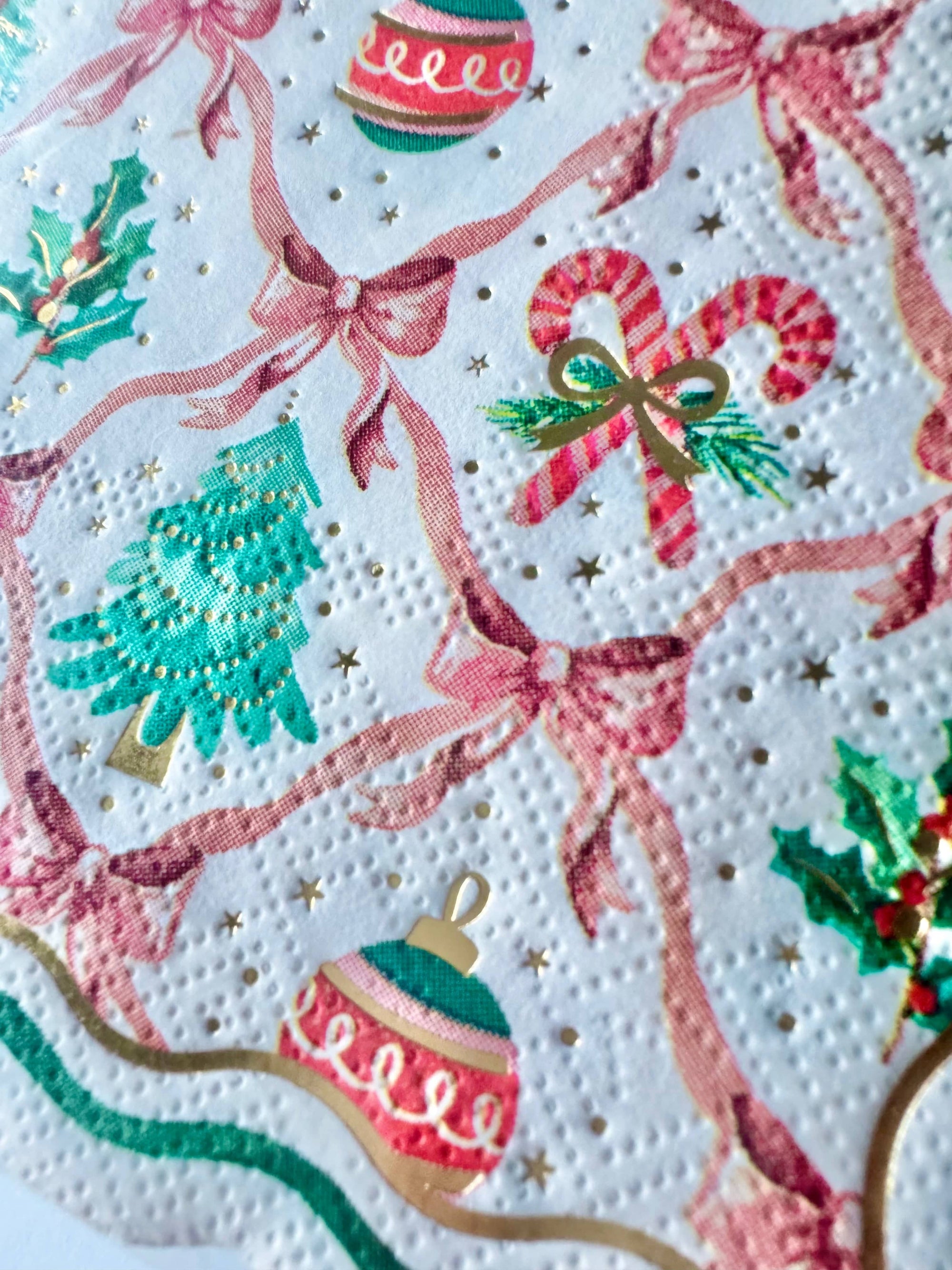 Christmas-themed pattern with ribbons, candy canes, and ornaments on a white background.