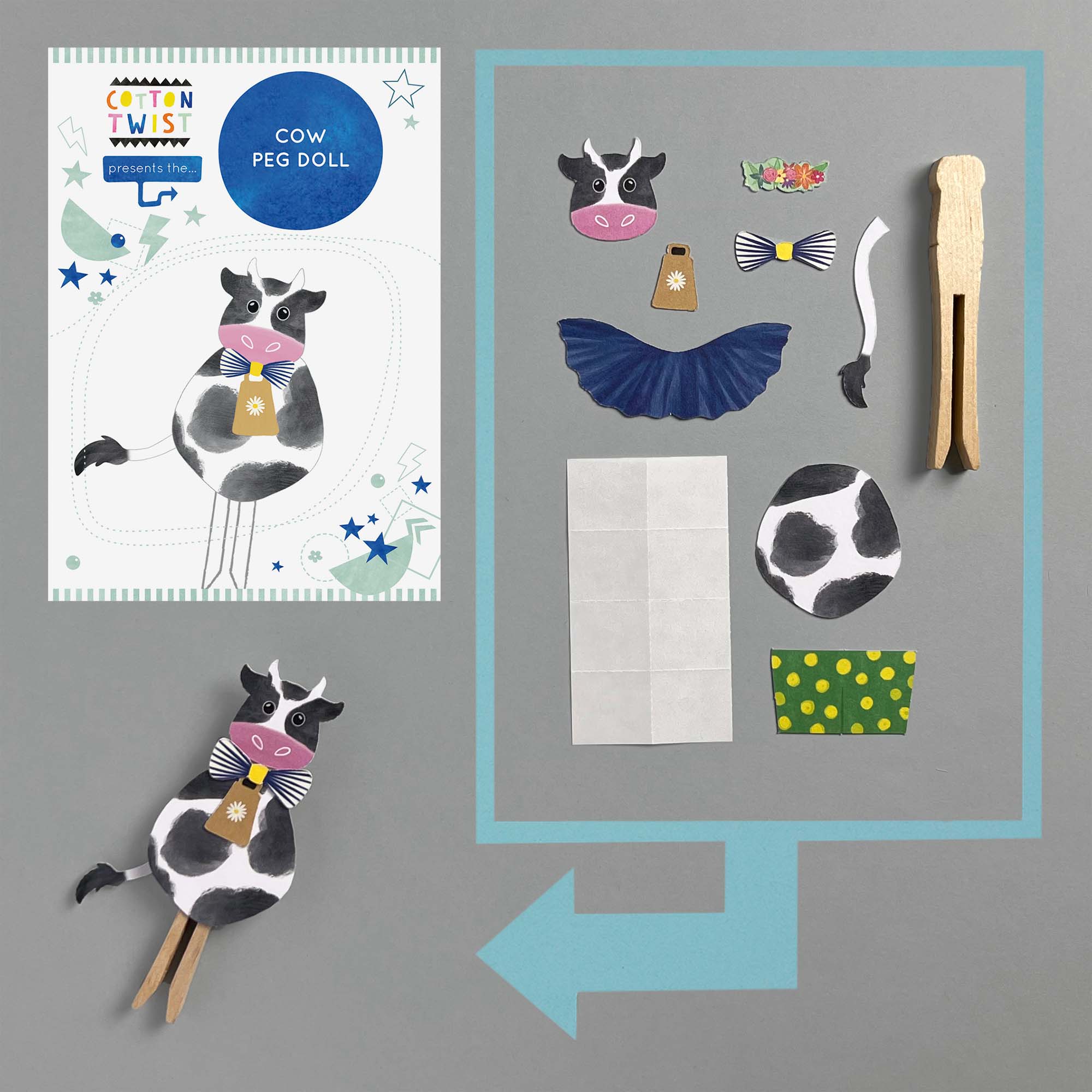 Cow peg doll with accessories on a gray background