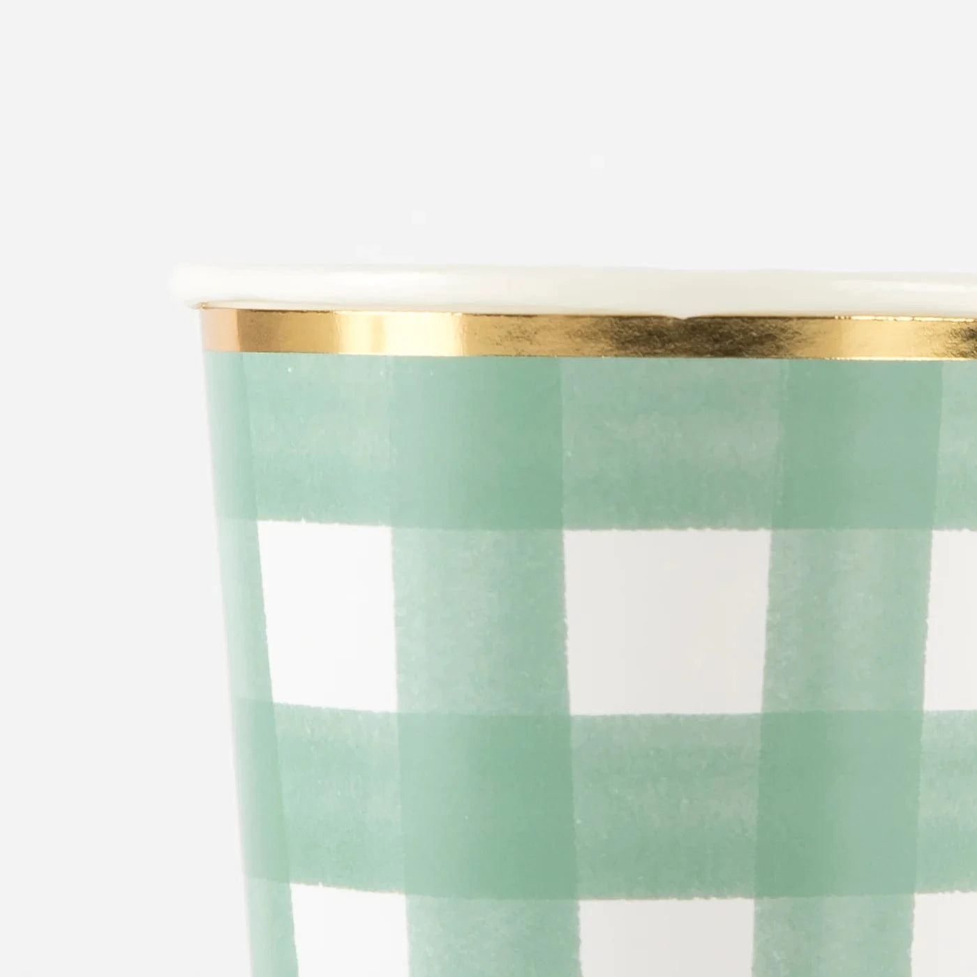 Green plaid party cups with a gold trim on a white background
