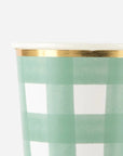 Green plaid party cups with a gold trim on a white background