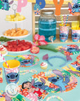Lilo and Stitch Hawaiian birthday party supplies with tropical blue drinks, character plates, cups, napkins, fruit platter and island themed decorations for Disney kids party