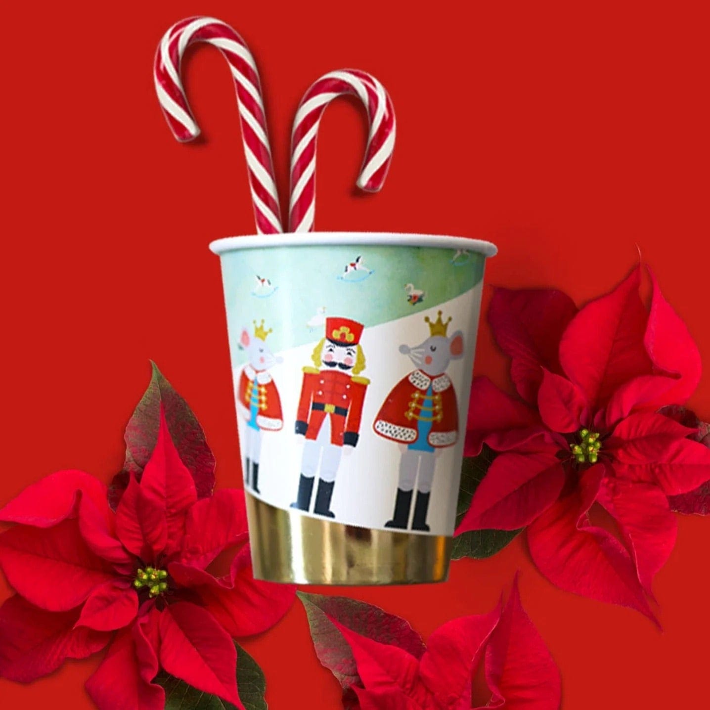Christmas-themed nutcracker party cup with candy canes and poinsettias on a red background