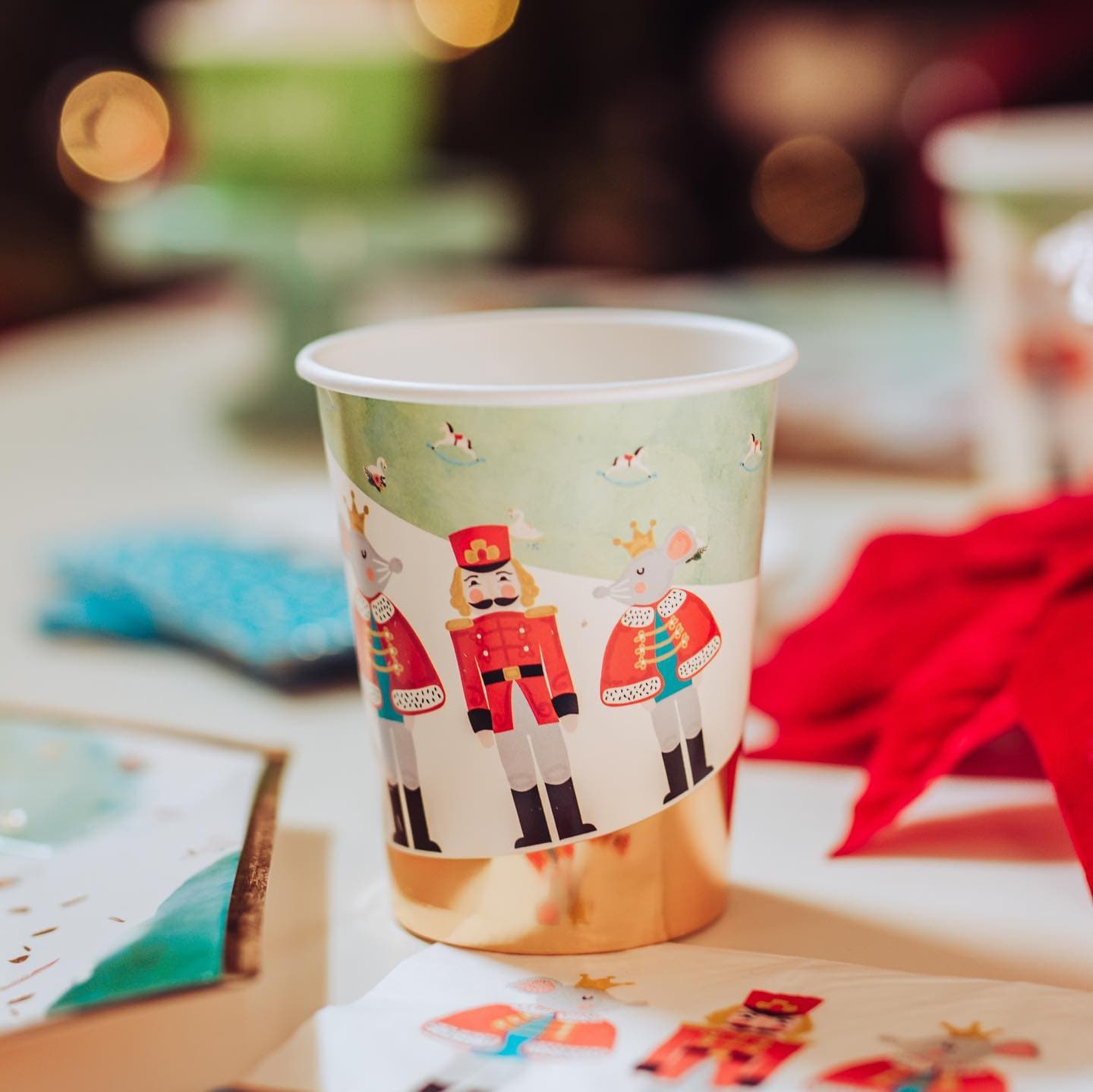 Paper cup with nutcracker design on a festive background