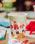 Paper cup with nutcracker design on a festive background
