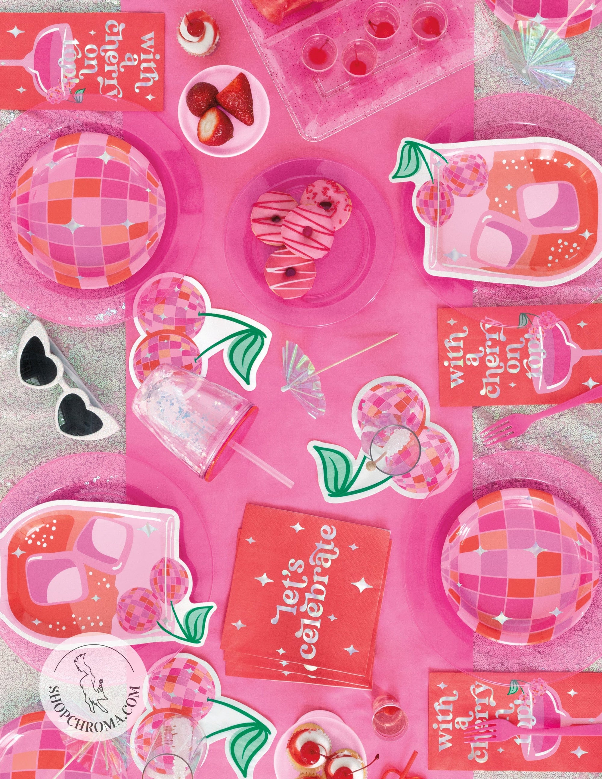 Pink disco ball party supplies with retro Let's Celebrate napkins, holographic plates, pink drink dispenser and glamorous sparkly decorations for trendy birthday party