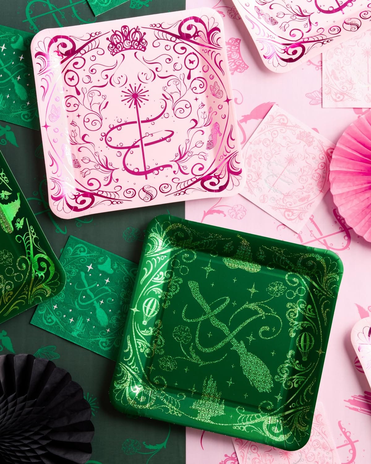Pink and green Wicked plate pair showing tiara and wand design beside witch hat and broom design