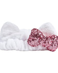 White Sanrio Hello Kitty bow headband with a pink sequin bow on a white background