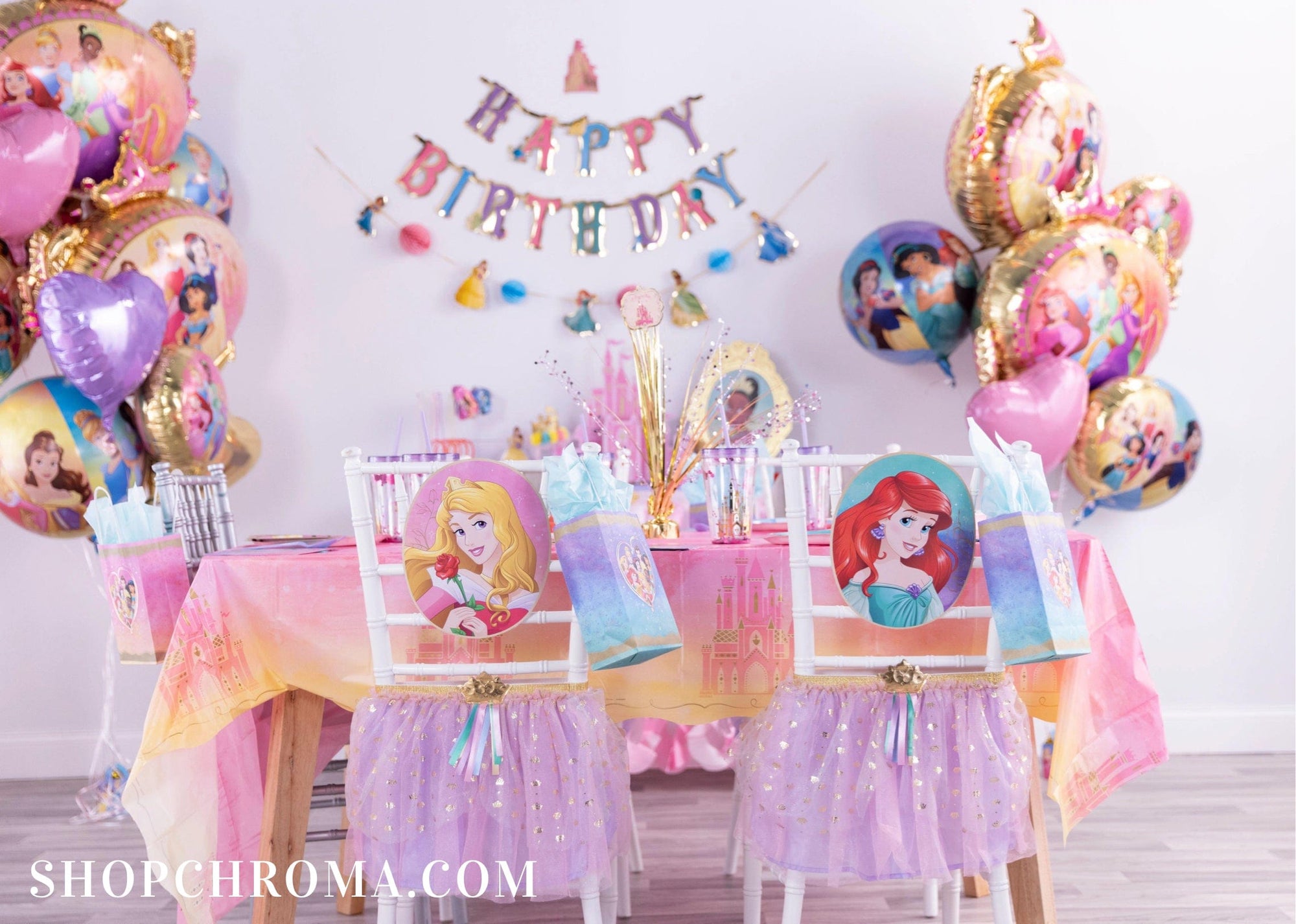 Disney Princess birthday party table with foil balloon bouquets, Happy Birthday banner, princess chair backs & Once Upon A Time tablecloth