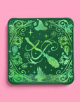 Green Wicked party plate with glitter foil witch hat, broom, and Emerald City skyline design