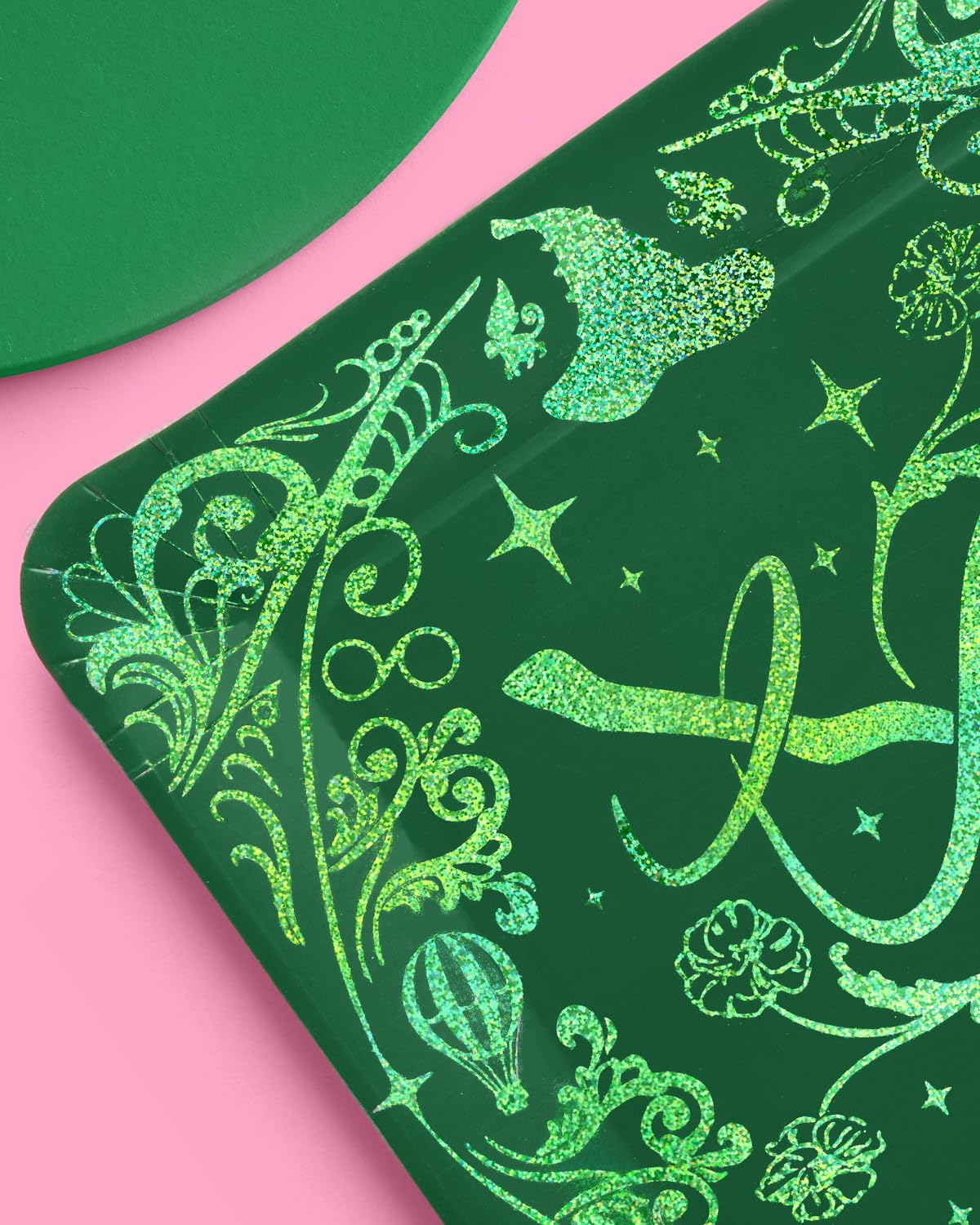 Emerald City Wicked plate closeup showing green glitter foil witch hat, broom, and hot air balloon details
