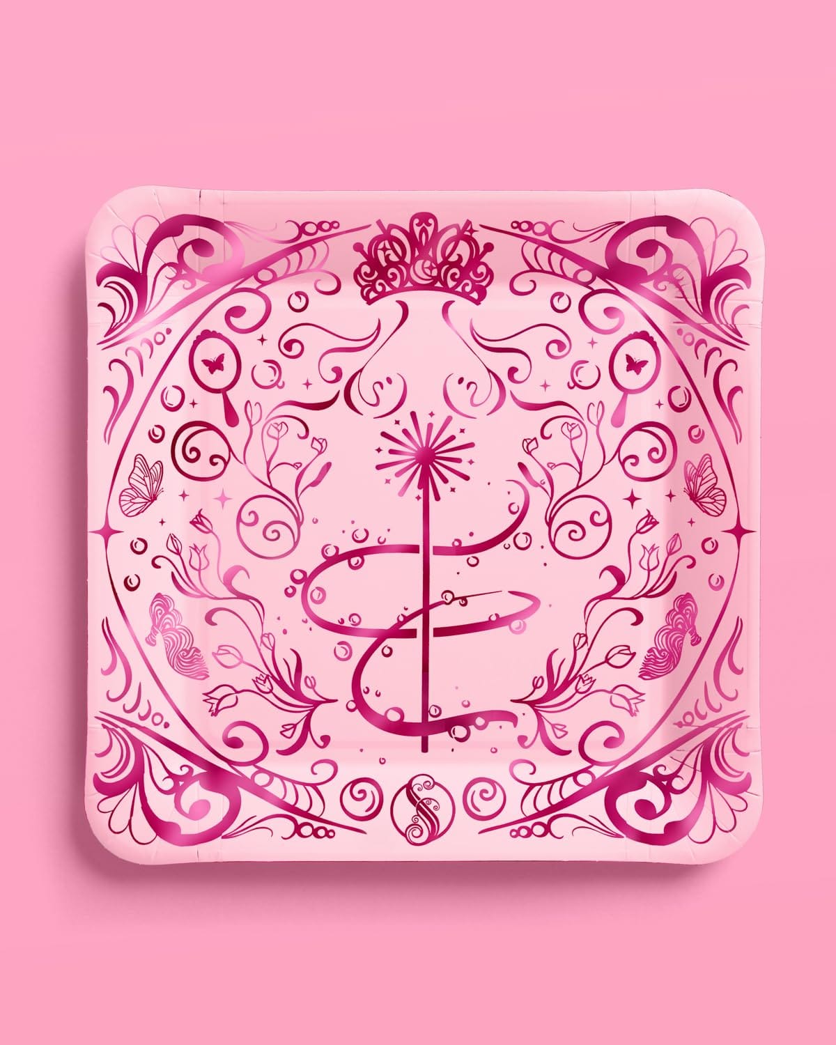 Pink Wicked party plate with dark pink foil tiara, sparkling wand, butterflies, and swirling florals