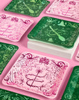 Emerald City Wicked plates in pink and green arranged on a pink table, square 10.5 inch dinner size