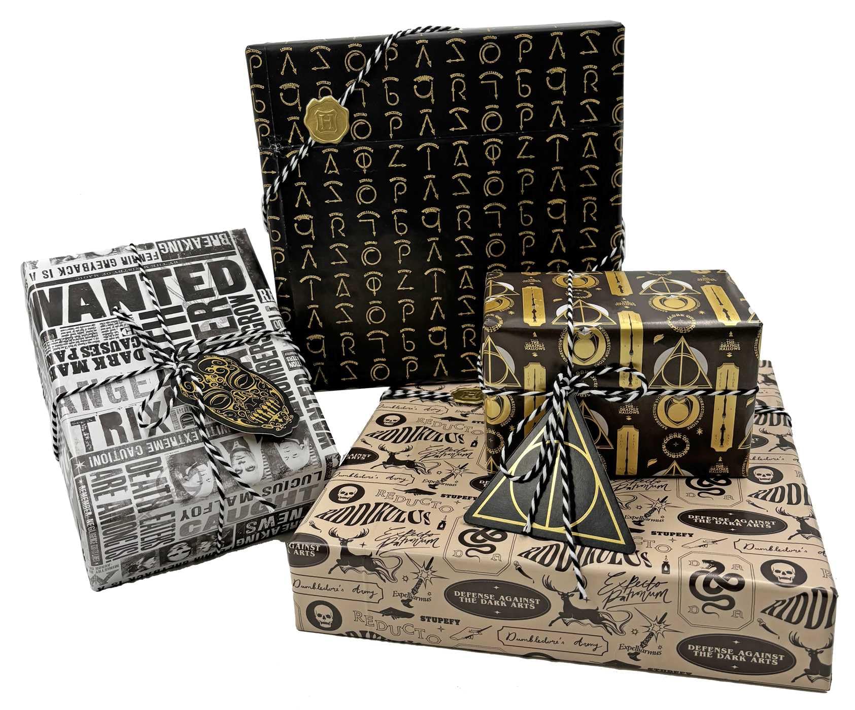 Harry Potter Dark Arts Gift Wrap Set displayed as four wrapped gifts showcasing all wrapping paper designs — black foil spell symbols, Daily Prophet Wanted poster, black and gold Deathly Hallows, and cream Defense Against the Dark Arts — each tied with black and white baker's twine with coordinating foil die-cut gift tags; complete Wizarding World party gift wrapping set for Harry Potter birthdays and themed events