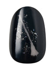 Close-up of Kiss x Wicked For Good  Elphaba's broomstick solid black oval press-on nail with diagonal silver glitter streak; short length waterproof fake nail