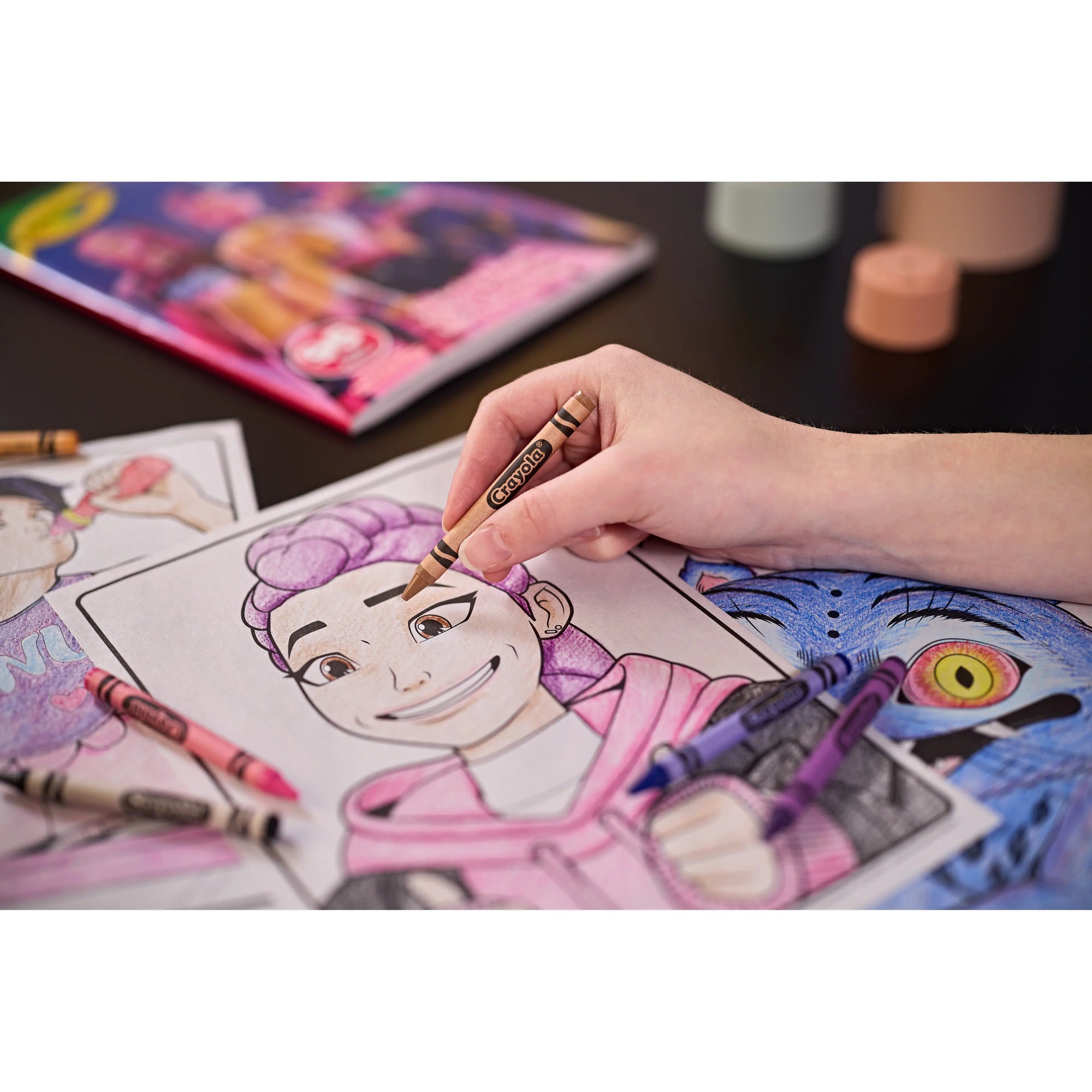Child colouring a Rumi page from the Kpop Demon Hunters colouring book with Crayola crayons