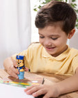 Boy using PAW Patrol Chase sticker stamper on activity book, screen-free party entertainment and travel activity for children's parties