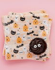 Pastel Halloween party napkins with chocolate cupcake - cute Halloween themed disposable napkins featuring pumpkins, ghosts, and black cats perfect for Halloween birthday party supplies