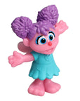 Sesame Street Abby Cadabby mini figurine party favour toy alternate angle, pink body and teal dress with purple pom-pom pigtails and blue eyes