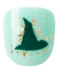 Close-up of mint blue kids press-on nail with deep green witch hat and gold glitter from the Wicked Perfect Duet nail kit