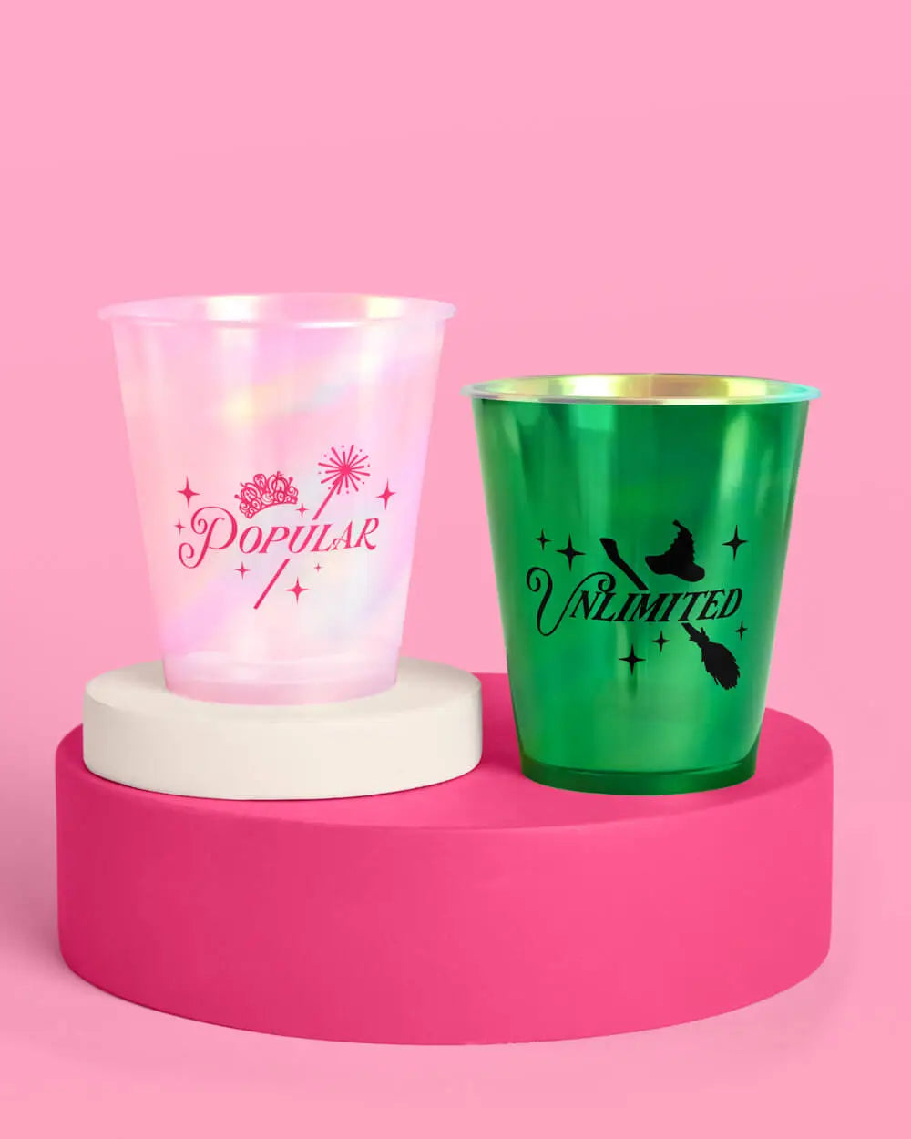 Wicked cup pair showing pink iridescent Popular cup with crown and green metallic Unlimited cup with witch hat and broom